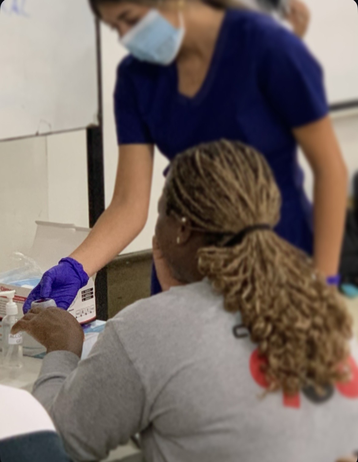 Community member receiving a blood pressure screening in Flint, Michigan