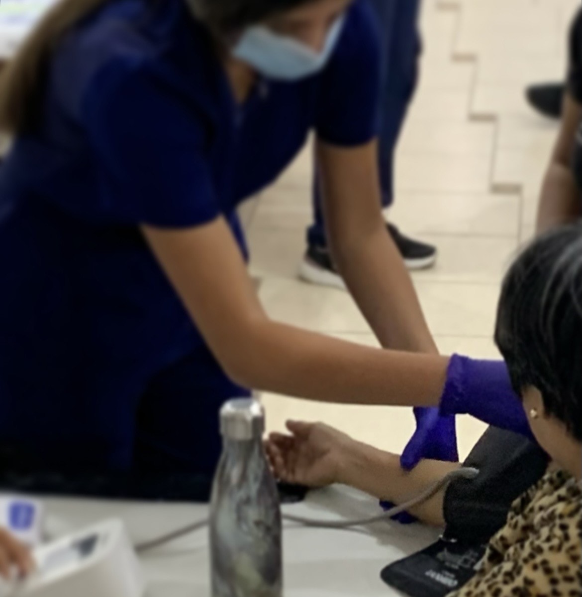 Healthcare volunteer supporting a community blood pressure screening in Flint, Michigan