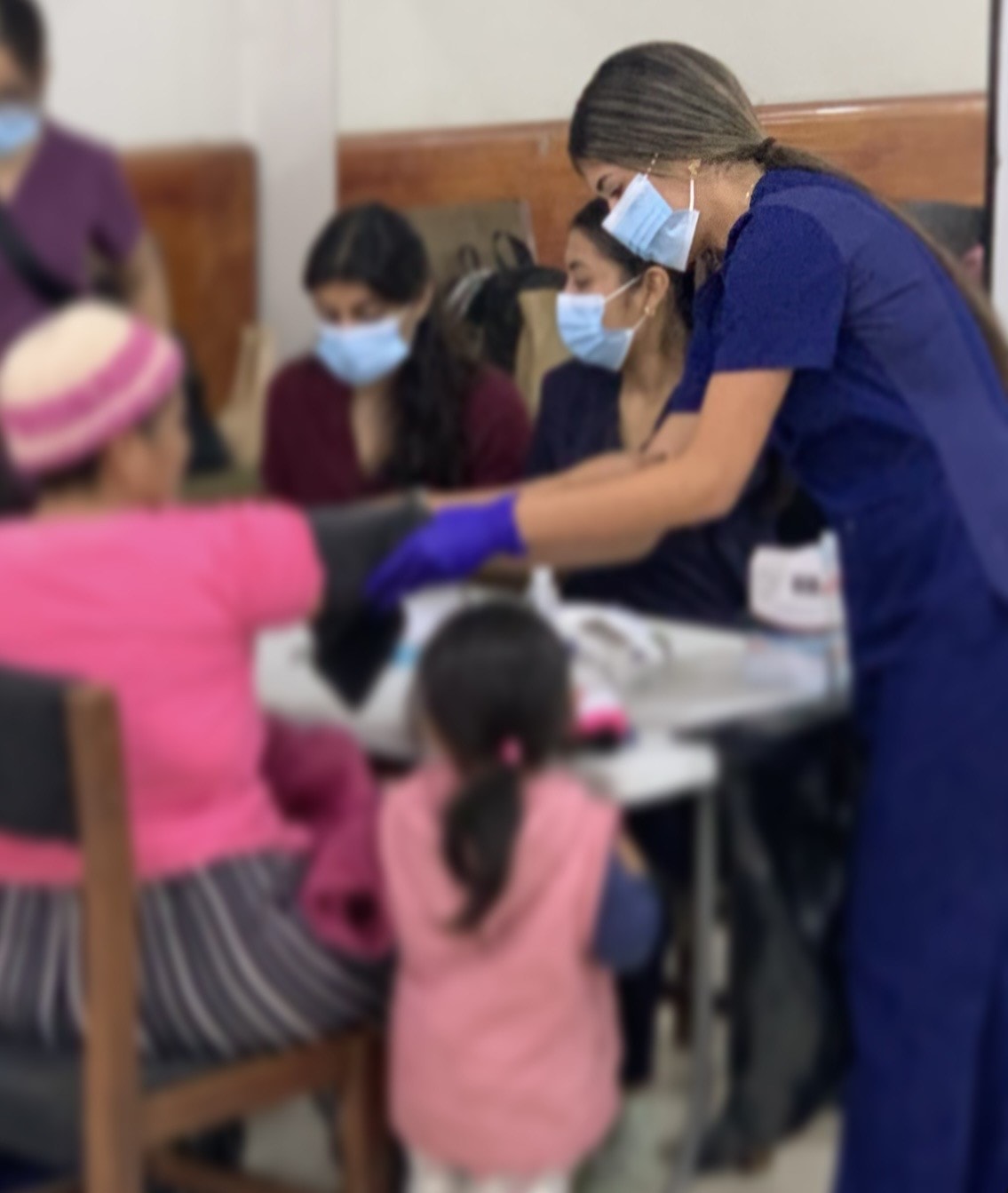 Healthcare worker providing a blood pressure screening in Lima, Peru