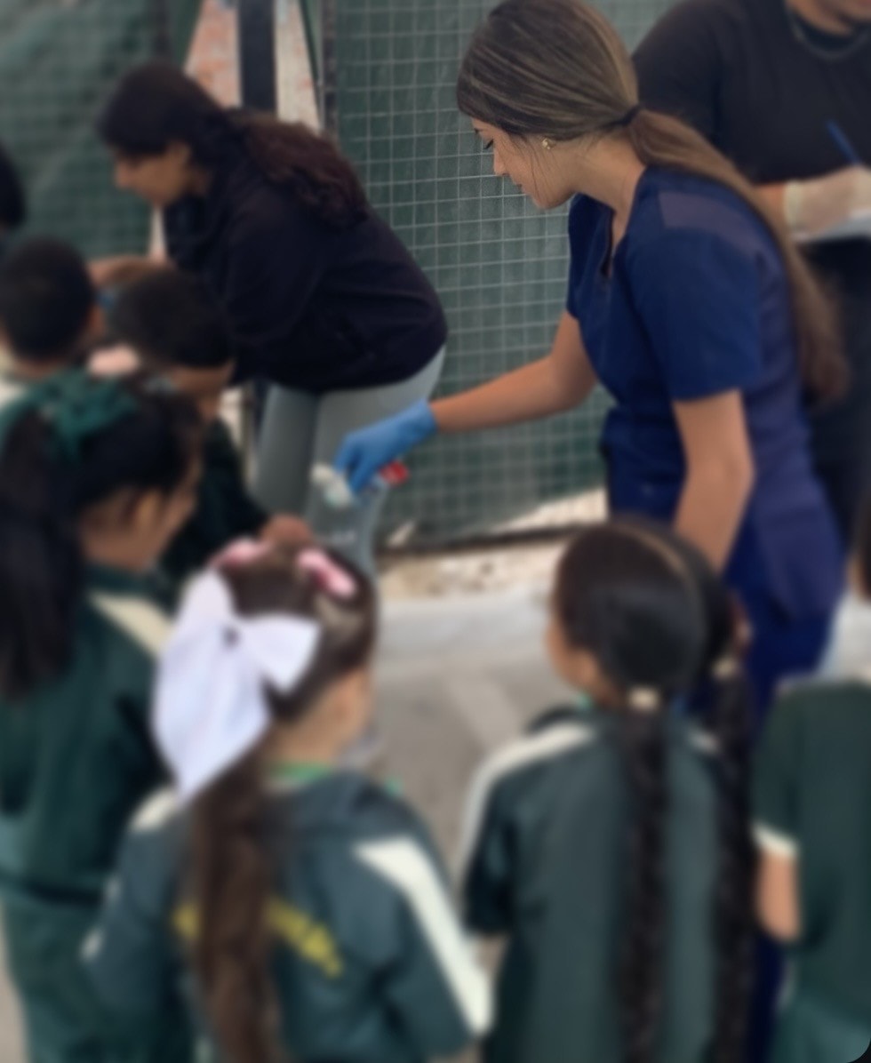 Healthcare volunteer leading a health education activity with children in Lima, Peru